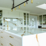 Gold/white Kitchen, Gold Lighting and sink with bespoke cabinetry